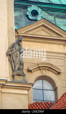 Stone statue on facade of Church of Saint Nicholas in Old Town Square Staré Město Prague Czech Republic. Stock Photo