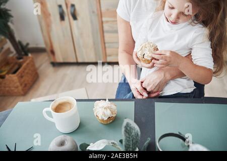 Weekend is chance to spend time together with family. Mother and daughter having good time in the kitchen Stock Photo