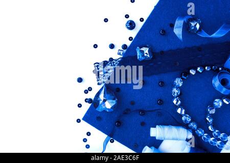 A set of materials for needlework in Classic Blue color on a white background. Stock Photo