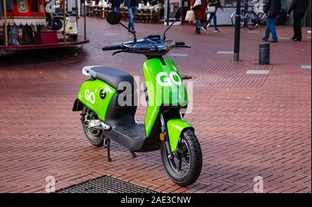 Eindhoven Netherlands. October 10, 2019. E scooter go sharing, green color, electric eco, parked in the city center. Stock Photo