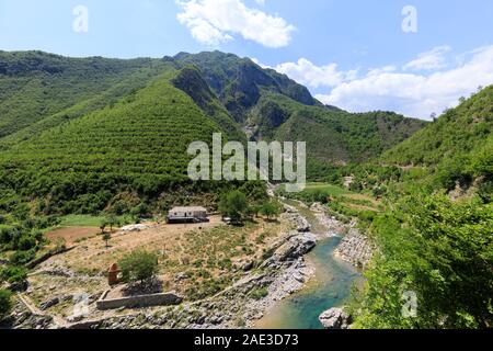 Heavenly landscape with green forests and a river with a farm in the Alps of Albania Stock Photo