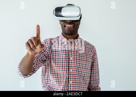 Waist up of a positive afro american man wearing VR glasses Stock Photo