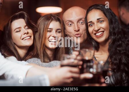 Going crazy. Beautiful youth have party together with alcohol in the nightclub Stock Photo