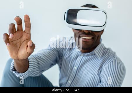 Close up of cheerful man using VR glasses Stock Photo