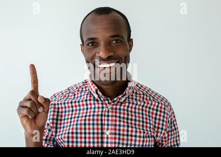 Close up of cheerful afro american man giving a piece of advice Stock Photo