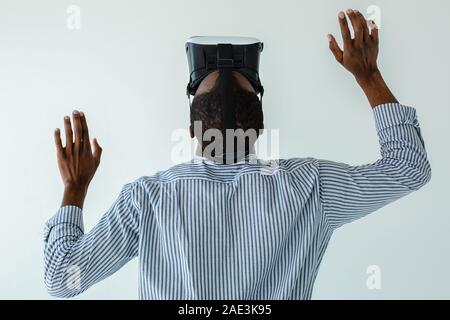 Waist up of afro american man wearing VR goggles Stock Photo