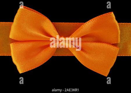 close up orange bow isolated on black background Stock Photo