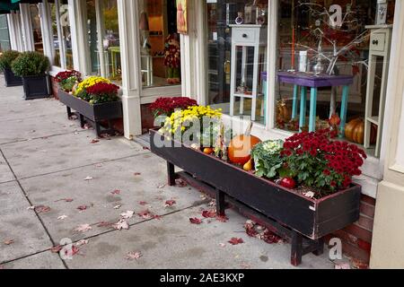 Woodstock, Vermont - September 30th, 2019:  Small shops decorated with Fall pumpkins in the historic New England town of Woodstock. Stock Photo