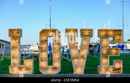 Illuminated Love sign in large letters at a wedding reception. Stock Photo