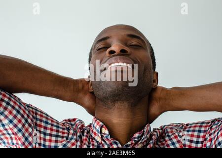 Portrait of afro american man closing his eyes in delight Stock Photo