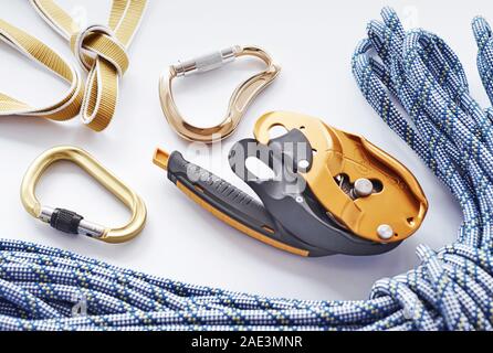 Big blue colored rope. Top view. Climbing equipment for the safeness lying on the white table. Conception of extreme sports Stock Photo
