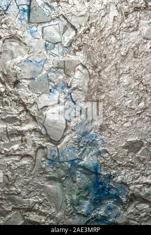 Silver grunge background with rough texture and blue spray paint discoloration Stock Photo