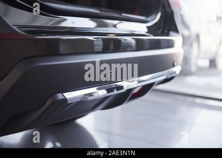 Rear part. Modern brand new black car in the saloon. Ready for the sale. Perfectly polished Stock Photo