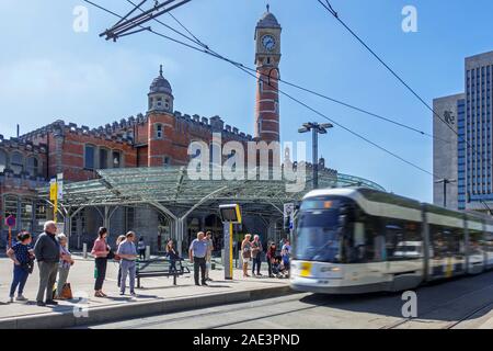 Entrance of the Gent-Sint-Pieters railway station and commuters waiting for tram in the city Ghent / Gent, East Flanders, Belgium Stock Photo