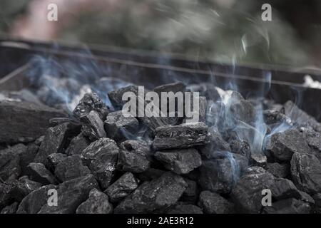 Smoke over the coals of a blacksmith's brazier Stock Photo