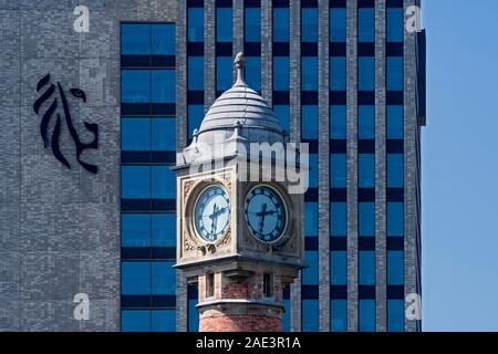 Gent-Sint-Pieters railway station clock tower and Virginie Loveling building / VAC, governmental office in the city Ghent, East Flanders, Belgium Stock Photo