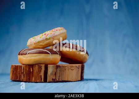 donuts lying on the table. blue background. Stock Photo