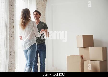 Adult dancers. Young couple celebrating their removal to the new house Stock Photo