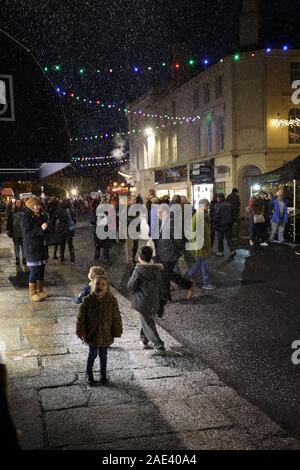Tavistock, UK. 6 December 2019. Crowds gather to celebrate the annual “Tavistock Dickensian Evening”. The evening is a magical late night shopping event that transports you back in time as shop keepers embrace the spirit and dress up in traditional attire, whilst the smell of chestnuts cooking on steam engines fill the streets. Credit: Julian Kemp/Alamy Live News. Stock Photo
