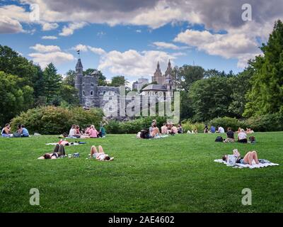 Belvedere Castle and people sunbathing, Central Park, Manhattan, New York City, New York, USA Stock Photo