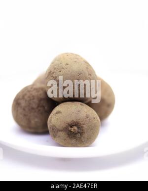 sapota fruit in white plate isolated on white Stock Photo