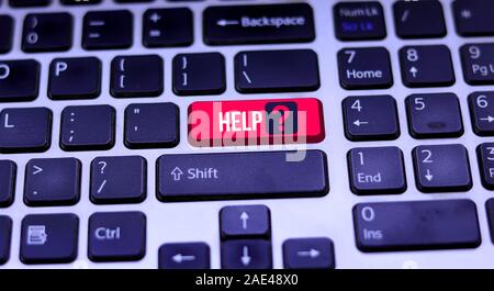 Laptop keyboard and red help key. Help keyboard button on the keyboards Stock Photo