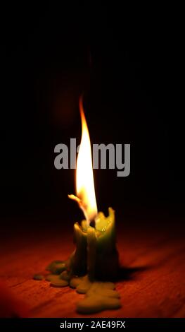 One light candle burning brightly in the black backgrounds Stock Photo