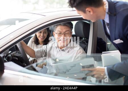 Happy mature couple taking a test drive Stock Photo