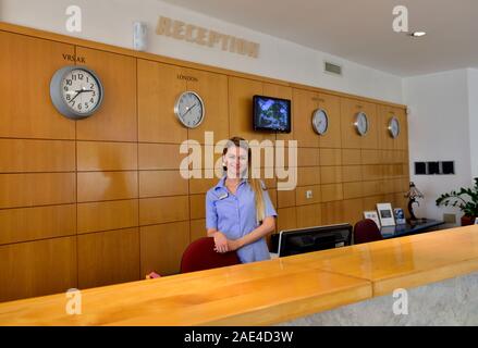 Hotel reception desk with woman receptionist, Hotel Pineta, Adriatic seaside town of Vrsar, Croatia Stock Photo