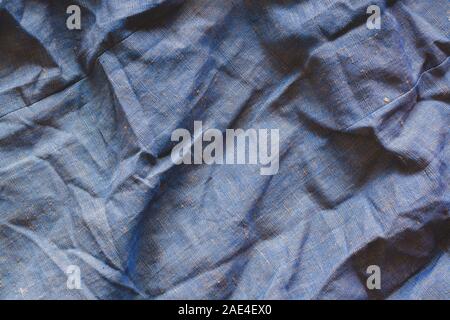 The texture of the fabric. Rough, dense fabric. Very wrinkled. Blue and yellow threads. Stock Photo