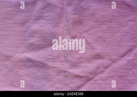 The texture of the fabric is pink. Horizontal stitches. The fabric is wrinkled. Stock Photo