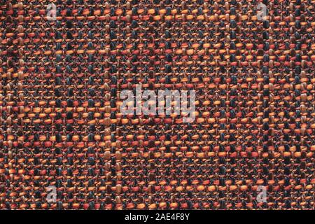 The texture of the fabric. Checkered fabric with fleecy threads of red, black and orange. Copy space. Stock Photo