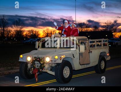 Fort Knox, USA. 05 December, 2019. Santa Claus along Mrs. Claus ride on a U.S. Army Humvee as they arrive at the 1st Theater Sustainment Command Holiday Tree Lighting Ceremony at Fowler Hall December 5, 2019 in Fort Knox, Kentucky.  Credit: Zoran Raduka/Planetpix/Alamy Live News Stock Photo