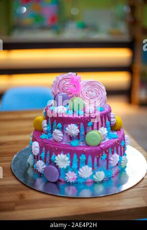 Beautiful cake for child s birthday. Candle in form of number 5 on cake. Decorated with marshmallows and macaroons cake. Blue with pink two-story cake Stock Photo