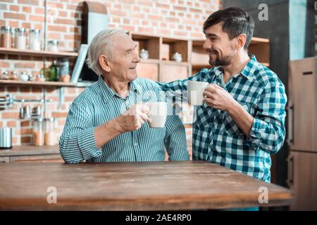Happy nice father and son having tea Stock Photo
