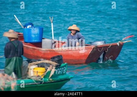 A commercial fisherman using nets on a very small fishing boat - Hong Kong Island's Aberdeen Harbour Stock Photo