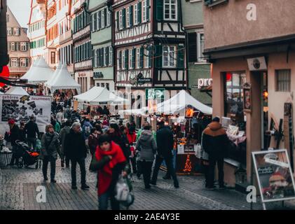 Tübingen, Germany - December 6, 2019: Chocolate market chocolART with christmas booths and stalls with many people standing in crowds drinking mulled Stock Photo