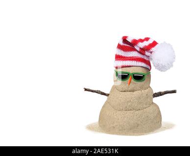 Christmas sandy snowman in sand with red and white striped hat isolated on white Stock Photo