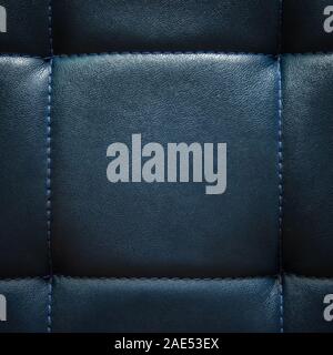 Shiny dark blue artificial textured leather stitched with blue thread. Close-up of sofa surface. View from directly above. Highly detailed square back Stock Photo