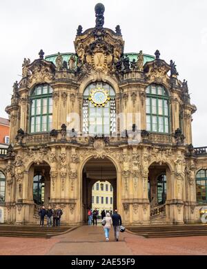 Tourists walking through archway of Baroque Glockenspiel Dresdner Zwinger Dresden Saxony Germany. Stock Photo