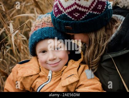 candid portrait of mother and son smiling whilst playing outside Stock Photo