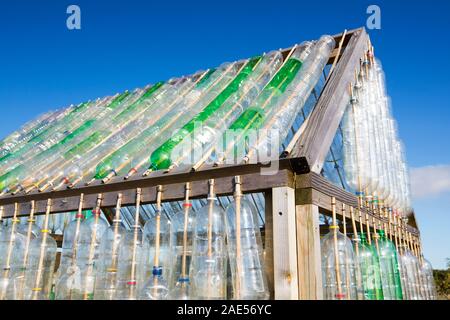 A greenhouse made from waste plastic drinks bottles in the community garden at Mount Pleasant Ecological Park, Porthtowan, Cornwall, UK. Stock Photo