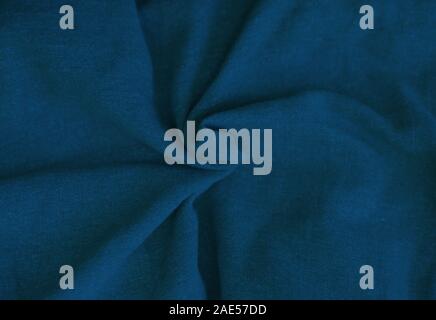 Crumpled blue fabric texture close up. Trendy tone of 2020 classic blue color, tissue background Stock Photo