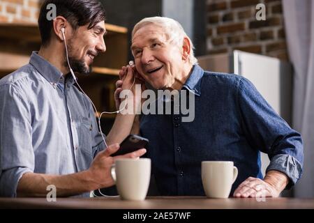 Joyful elderly man talking on smartphone Stock Photo