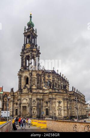 Tourists walking towards baroque Cathedral of the Holy Trinity Katholische Hofkirche Altstadt Dresden Saxony Germany. Stock Photo