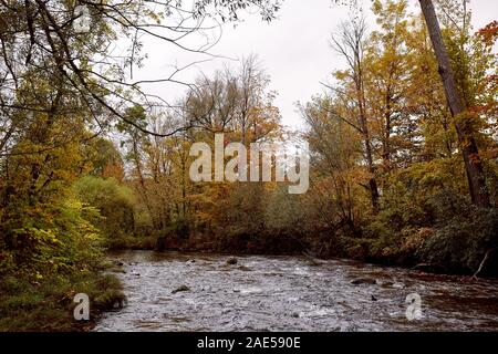 Walloomsac River surrounded by fall foliage near Papermill Village Bridge in the New England town of Bennington, Vermont Stock Photo