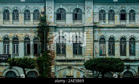 Decaying facade of an the old British colonial building, formerly the Accountant-General's office, on the corner of Strand Rd and Pansdodan St in Yangon (formerly Rangoon), Myanmar (Burma) Stock Photo