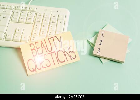 Text sign showing Beauty Questions. Business photo text a sentence or phrase used to find out information Paper blue desk computer keyboard office stu Stock Photo