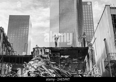 Los Angeles, California, USA - 1988:  Archival black and white editorial view of demolition worker throwing door off building on Hill Street near 4th. Stock Photo