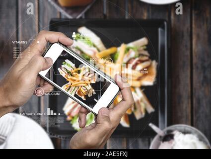 Food Nutrition Scanning Technology, and Healthy eating Lifestyles. a man using mobile smart phone checking nutrition facts Stock Photo